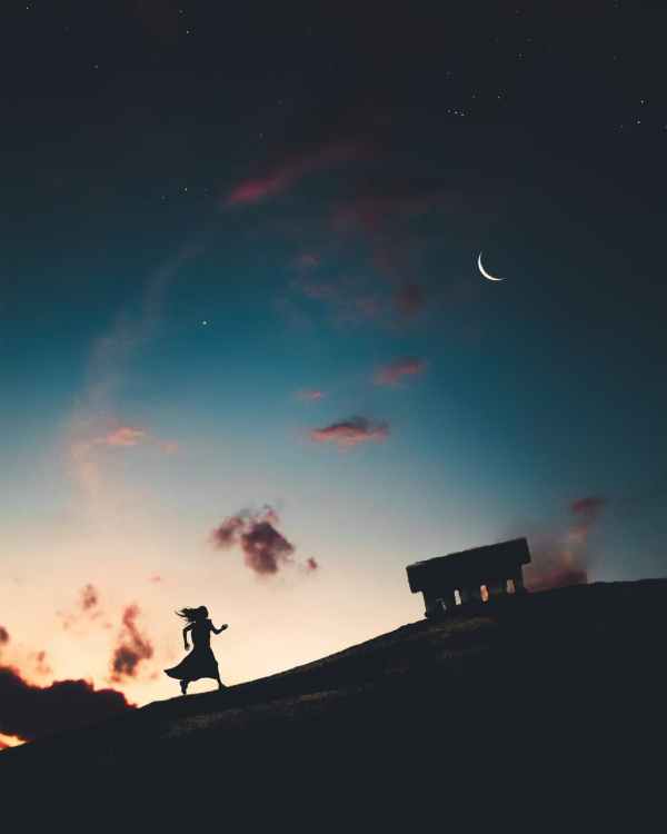 Picture of woman running on a hill under the sky with stars